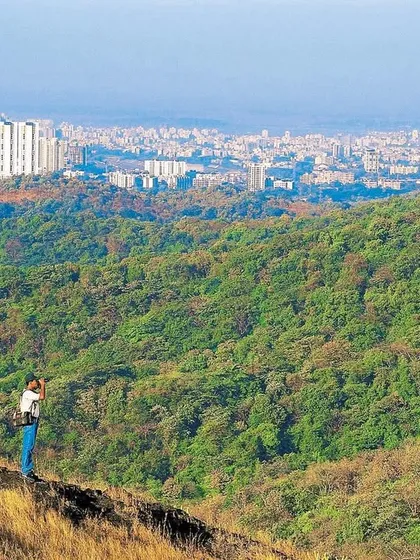 My friend scans the terrain from a ridge in SGNP in the late 1990s. The burgeoning western suburbs in the distance present the stark contrast that earns this wilderness the name 'City Forest'.