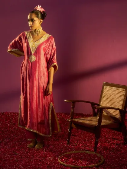 A full-length shot from the Kashidaa campaign, where I served as both stylist and creative director. The scene is set with a floor of rose petals, contrasting the rich pink of the silk kurta against a magenta background.