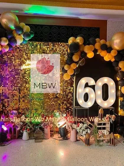 This view captures the full ambiance of the 60th-anniversary party, with the glowing marquee numbers and colorful party lights.