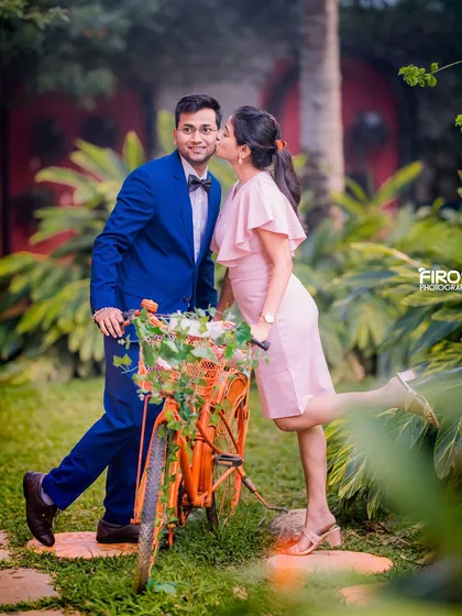A playful and romantic moment with a bicycle in the garden.