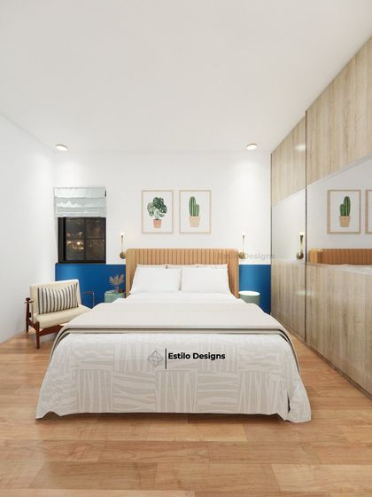 This guest bedroom is an exercise in simple, minimal design. A pop of blue on the accent wall, paired with light wood tones and simple botanical prints, creates a fresh, uncluttered, and welcoming space for visitors.