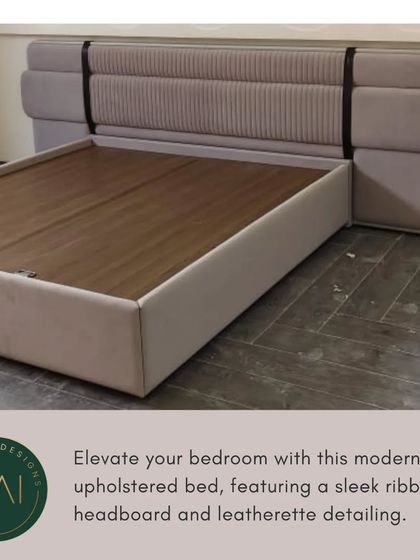 This modern upholstered bed features a sleek, ribbed headboard with distinctive leatherette strap detailing. It's a unique design that adds a touch of industrial chic to a contemporary bedroom.