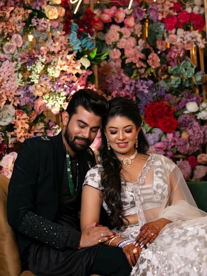 A beautiful candid moment between the couple. The makeup is designed to look stunning in professional photos, capturing the joy and romance of the day.