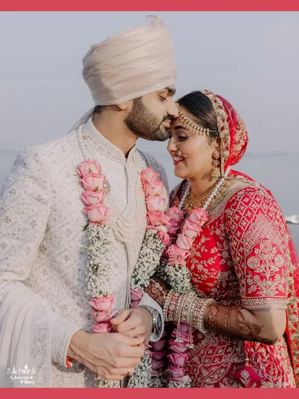 A tender moment as the groom, Jimit, kisses his bride's forehead. A classic, romantic shot that overflows with love.