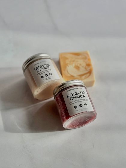 A beautiful, sunlit shot of a custom bundle featuring our Tropical Escape polish, Rose-tic Charm salt soak, and a Haldi Doodh soap bar.