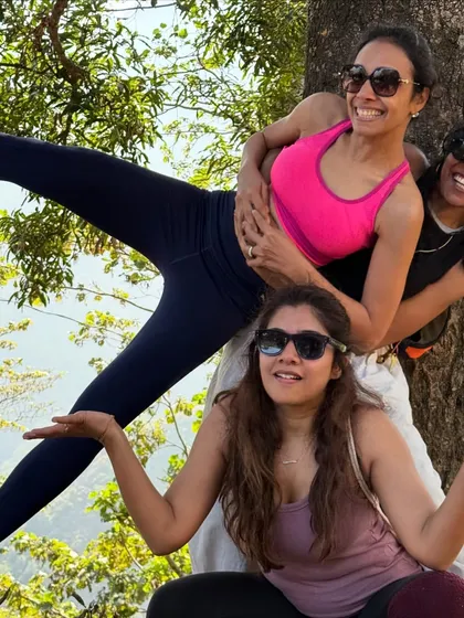 Three women striking a playful pose during our hike. The laughter and camaraderie shared on these adventures are just as healing as the yoga practice itself.