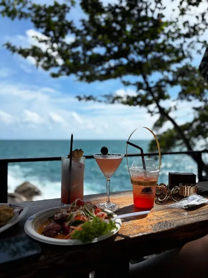 Cocktails and food with a view at a stunning cliff cafe in Phuket. This is perfect content for promoting hospitality brands.