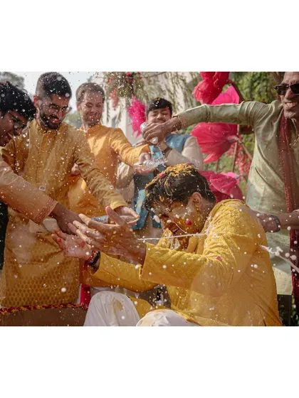 Do you know what December-fest is? It’s when grooms like Aayush get showered with cold beer on a winter morning. This shot captures the wild and fun traditions that friends create.