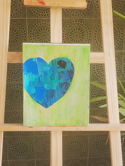 Another view of my tranquil blue and green heart on the easel. The background tiles add a nice contrast to the modern, textured art. This piece is perfect for a space where you want to feel calm and centered.