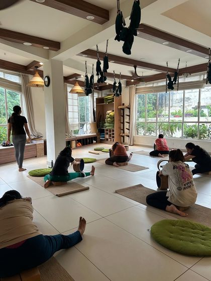 A class using yoga wheels for a deep hamstring and hip stretch. The wheel provides support while allowing for a greater range of motion.