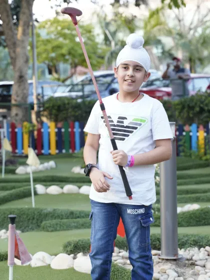 A moment of focus on our mini-golf course. It's a perfect activity for families to enjoy together, offering a calmer but equally engaging challenge.