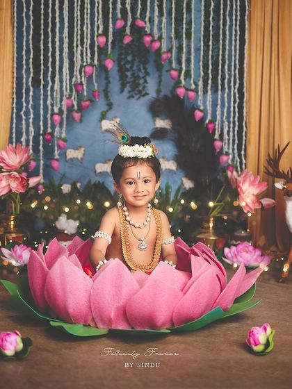 A close-up of a baby Krishna sitting in a lotus, looking absolutely divine.