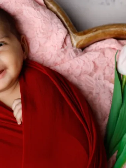 Petals and giggles. This baby's infectious smile is the highlight of this beautiful floral setup, complete with a heart-shaped basket and tulips.