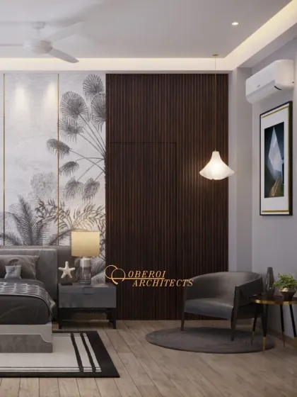 This view shows a cozy reading chair and a hidden door within the wood-paneled wall, a clever design feature that maintains the room's clean aesthetic.