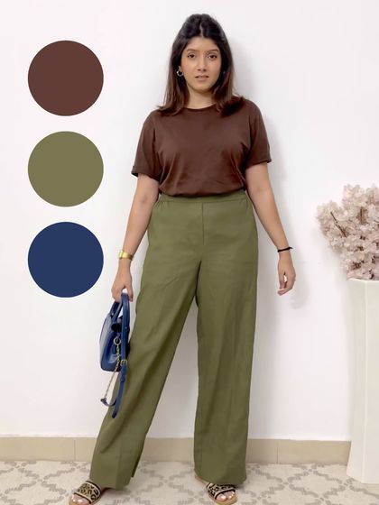 An earthy and sophisticated color combination. This outfit pairs a brown t-shirt with olive green trousers and a navy blue bag for a grounded and stylish look.