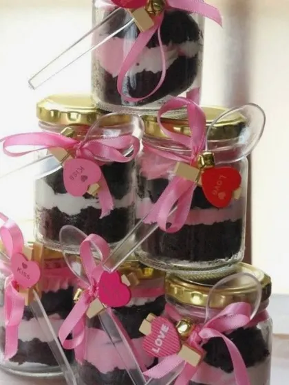 A tower of my mini dessert jars, perfect for Rakhi or any celebration. These jars are layered with chocolate cake and pink cream, and each comes with its own little spoon.