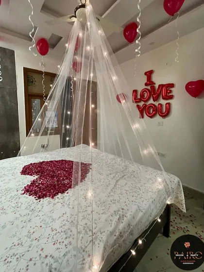 A romantic room setup with an "I LOVE YOU" foil balloon message, perfect for an anniversary or just a special surprise.