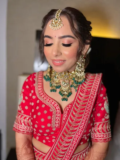 Another angle of Akshita's flawless bridal look, highlighting the seamless skin finish and the beautiful harmony between her makeup and jewelry.