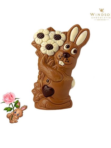 A large chocolate rabbit sculpture holding a bouquet of white chocolate flowers, demonstrating my skill with multi-part, detailed figures.