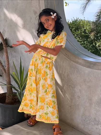 Another angle of our little sunshine in her favorite yellow floral dress. It’s a testament to how a comfortable outfit can bring out the brightest smiles.