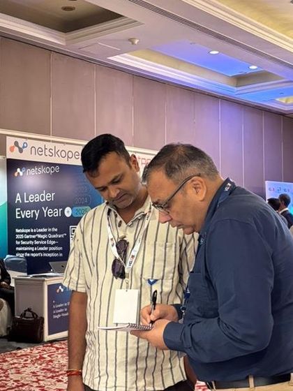 Our team member engaging in a detailed discussion with a visitor at our booth during the Bharat PSU Manthan 2025 event.