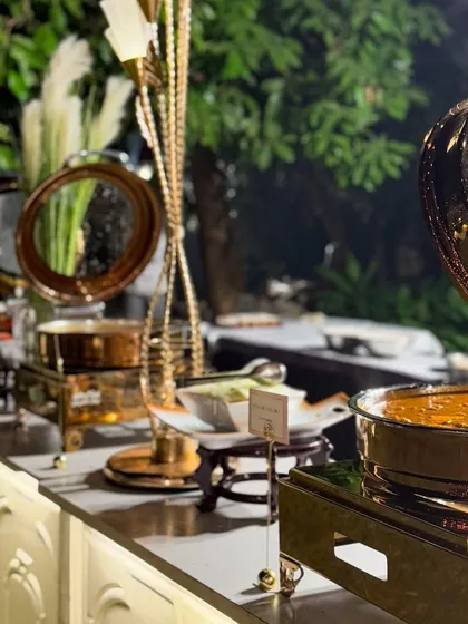 A wide view of my buffet counters, showcasing the elegant copper and gold chafing dishes that keep the food warm and add a touch of royalty to the spread.