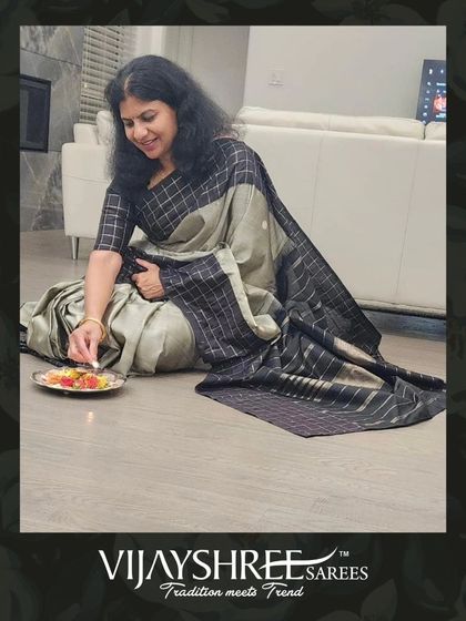 Sumana Chebrolu celebrating a festival at home, draped in a sophisticated grey and black checked Kanjivaram.