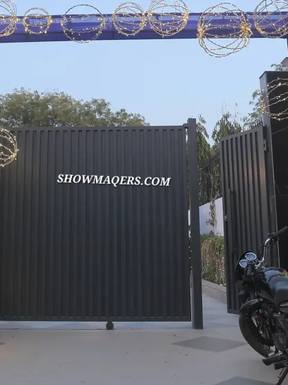 The entrance gate to the venue, decorated with an arch of blue fabric and illuminated spheres.