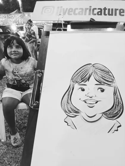 A black and white portrait of a young girl at an evening flea market. My classic ink style is timeless and captures personality beautifully.