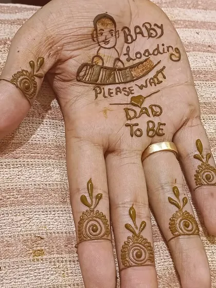 A simple and sweet mehendi for the father-to-be, with "Dad to be" and a "Baby Loading" graphic. It's a fun way for dads to join in the celebration.