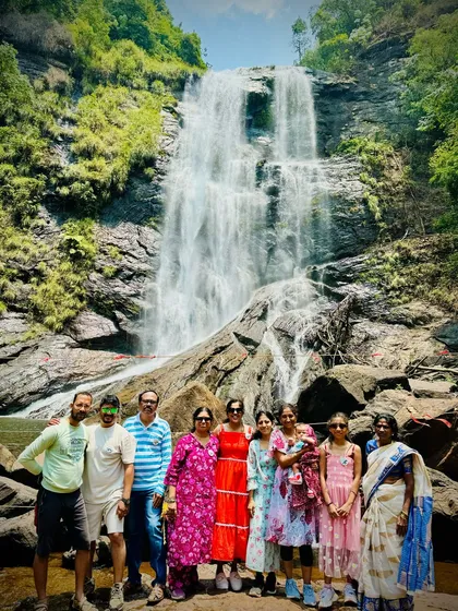 A family group enjoying the view of Hebbe falls in Chikmagalur, showing that our trips are for everyone.