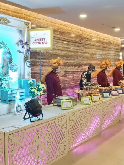 Here is our team at a sweet counter, dressed in traditional Rajasthani attire. We specialize in themed events and add authentic touches like staff uniforms to enhance the cultural experience of your celebration.