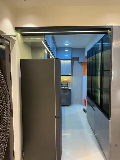 This kitchen in grey tones features a sleek, modern look with handleless cabinets and integrated LED strip lighting for a futuristic feel.