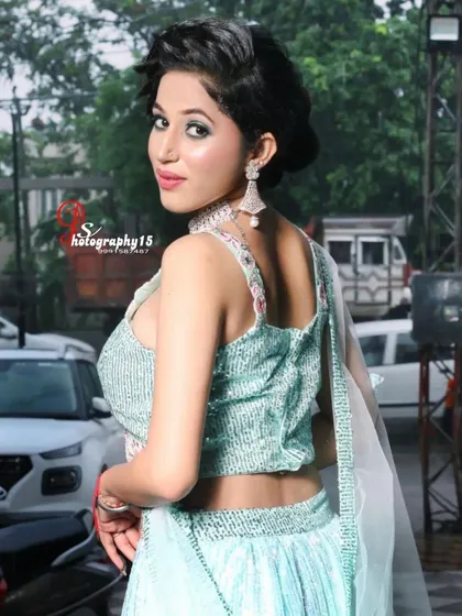 A back view of the stylish blouse on the sea-green lehenga. The cut-out detail adds a modern and trendy touch to the outfit.
