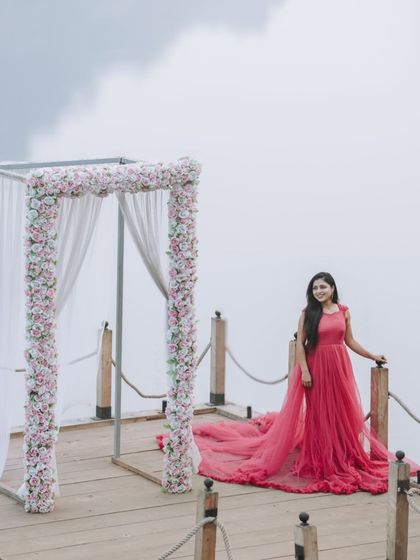 This solo portrait showcases the full length and trail of the pink gown. It's a perfect choice for creating a grand and elegant statement in your maternity photos.