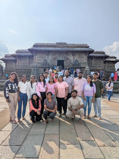 A group exploring the intricate carvings of a temple in Chikmagalur. I love sharing the stories behind these ancient works of art with my groups.