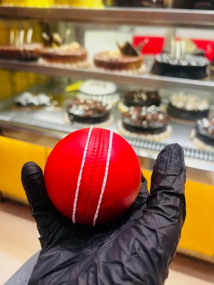 Can you believe this is a cake? I sculpted this hyper-realistic cricket ball, perfect for a cricket fan's birthday. It looks so real, you might be tempted to play with it!