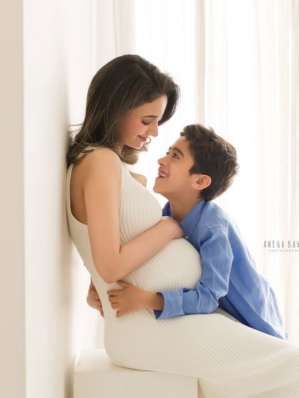 The special bond between a mother and her son shines in this softly lit maternity photo. His adoring gaze is a perfect example of the love I aim to capture.