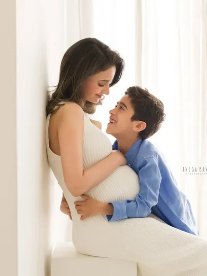 The look of pure adoration between a mother and her son. These intimate moments are the heart of a family maternity session, captured with soft window light in my studio.