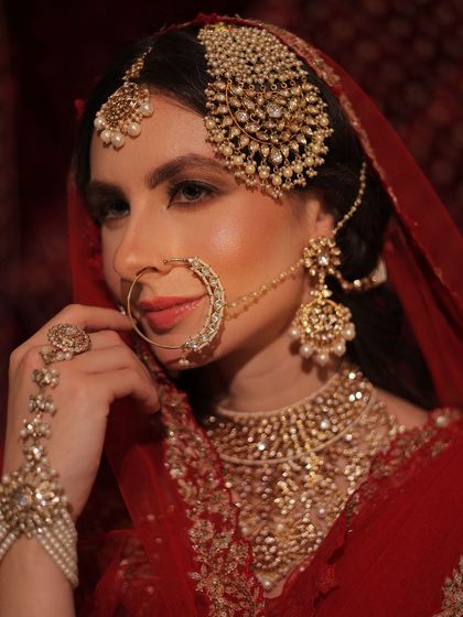 Another angle of the royal bride, focusing on her stunning jewelry and the clean hairstyle that supports it.