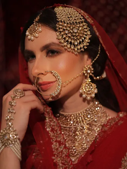 Another angle of the royal bride, focusing on her stunning jewelry and the clean hairstyle that supports it.