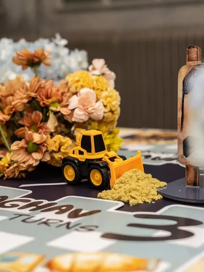 This shot captures the mix of playful toys and elegant florals that defined the construction party's unique aesthetic.