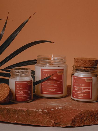 My scented candles are designed to help you relax and unwind. This image shows my "Wild Oudh Earth" candle, hand-poured with pure soy wax and available in different jar styles, including this one with a cork lid.