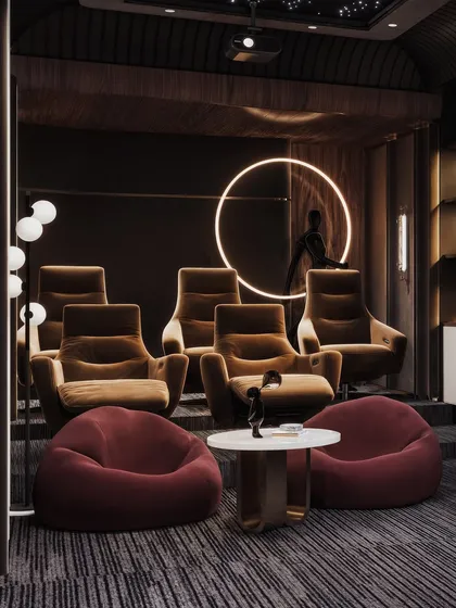 This angle shows the full seating arrangement of the home theater, including plush recliners and casual beanbags, catering to different viewing preferences. The circular neon light adds a futuristic touch.