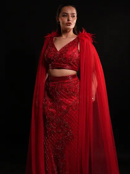 Where craftsmanship meets couture. This red straight-fit outfit with a dramatic cape from our High Ball Collection is elegance in every stitch.