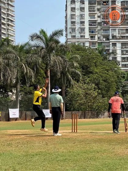 A bowler in a yellow jersey is in full flight during his delivery at the Parents Premier League.