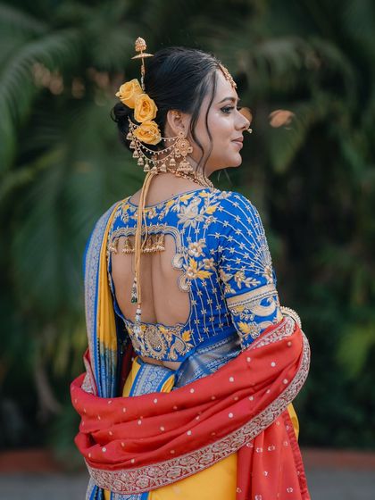 A beautiful shot of the back, highlighting the intricate blouse design and floral bun.