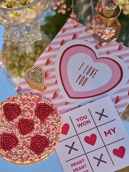 More of the custom-designed stationery, including the "I Love You" card and beaded coaster, reflecting the couple's playful personality.