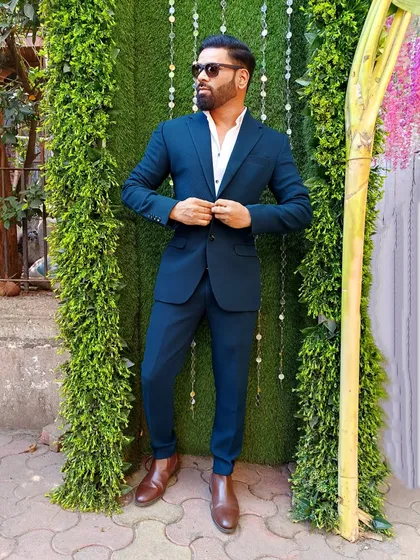 A classic and sharp look with a well-fitted blue suit. This demonstrates my ability to dress formally for any high-end corporate or wedding function.