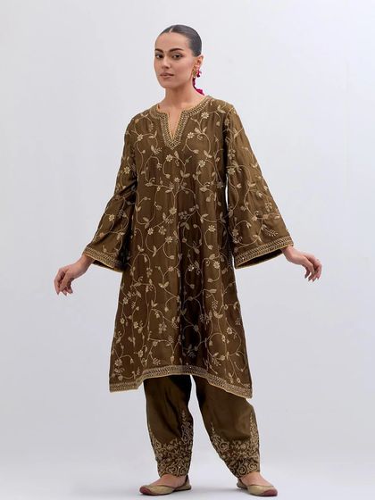 An earthy brown kurta set featuring all-over delicate floral vine embroidery in a lighter thread, paired with embroidered trousers.
